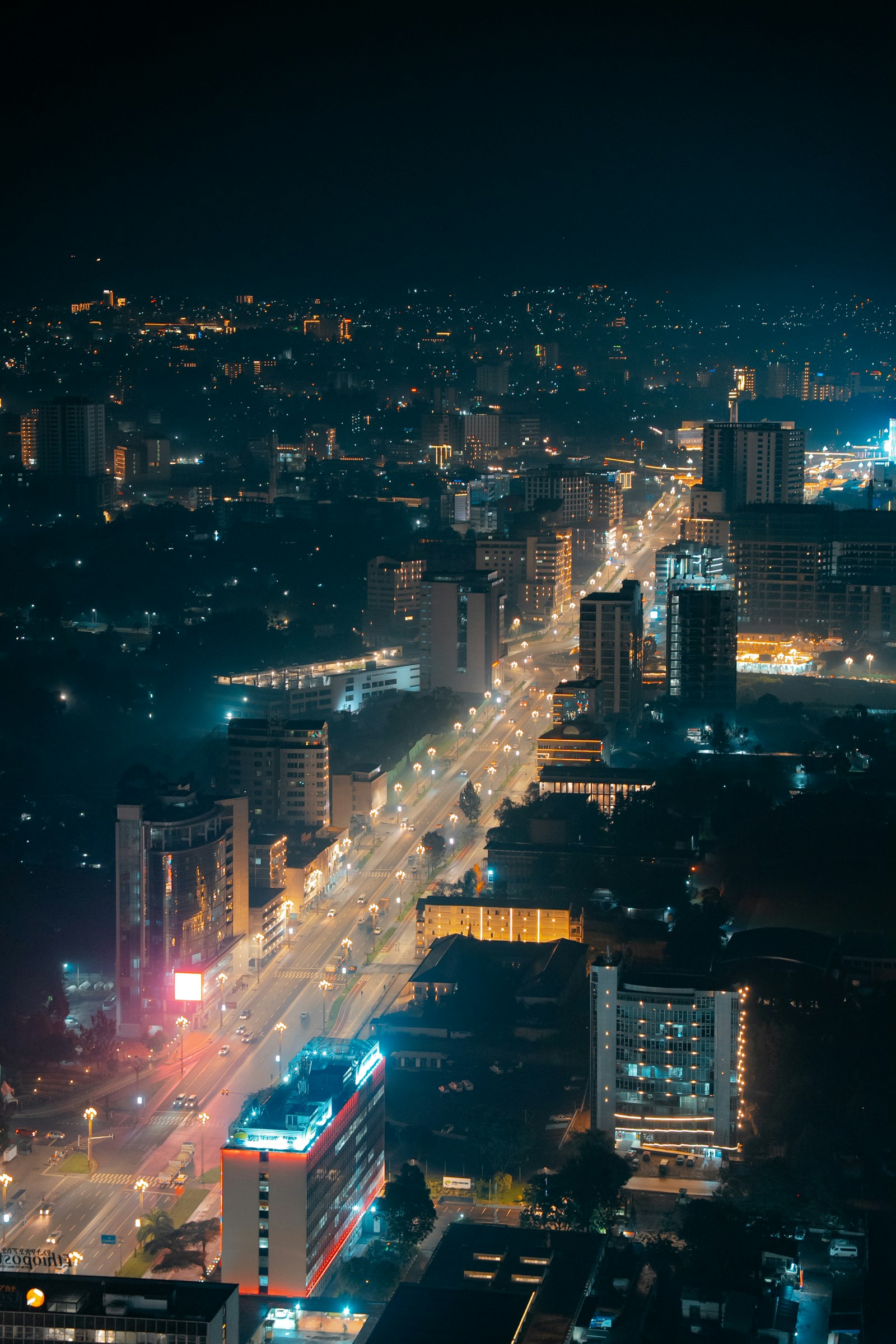 Night view of Addis Ababa looking down a lit main avenue toward the skyline