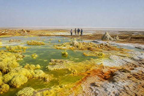 Yellow, green, orange, and white mineral formations across the Dallol hydrothermal landscape in Ethiopia's Danakil Depression