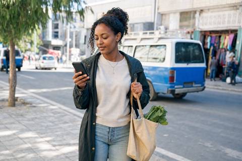 An Ethiopian phone user organizing useful local apps for payments, transport, maps, and travel
